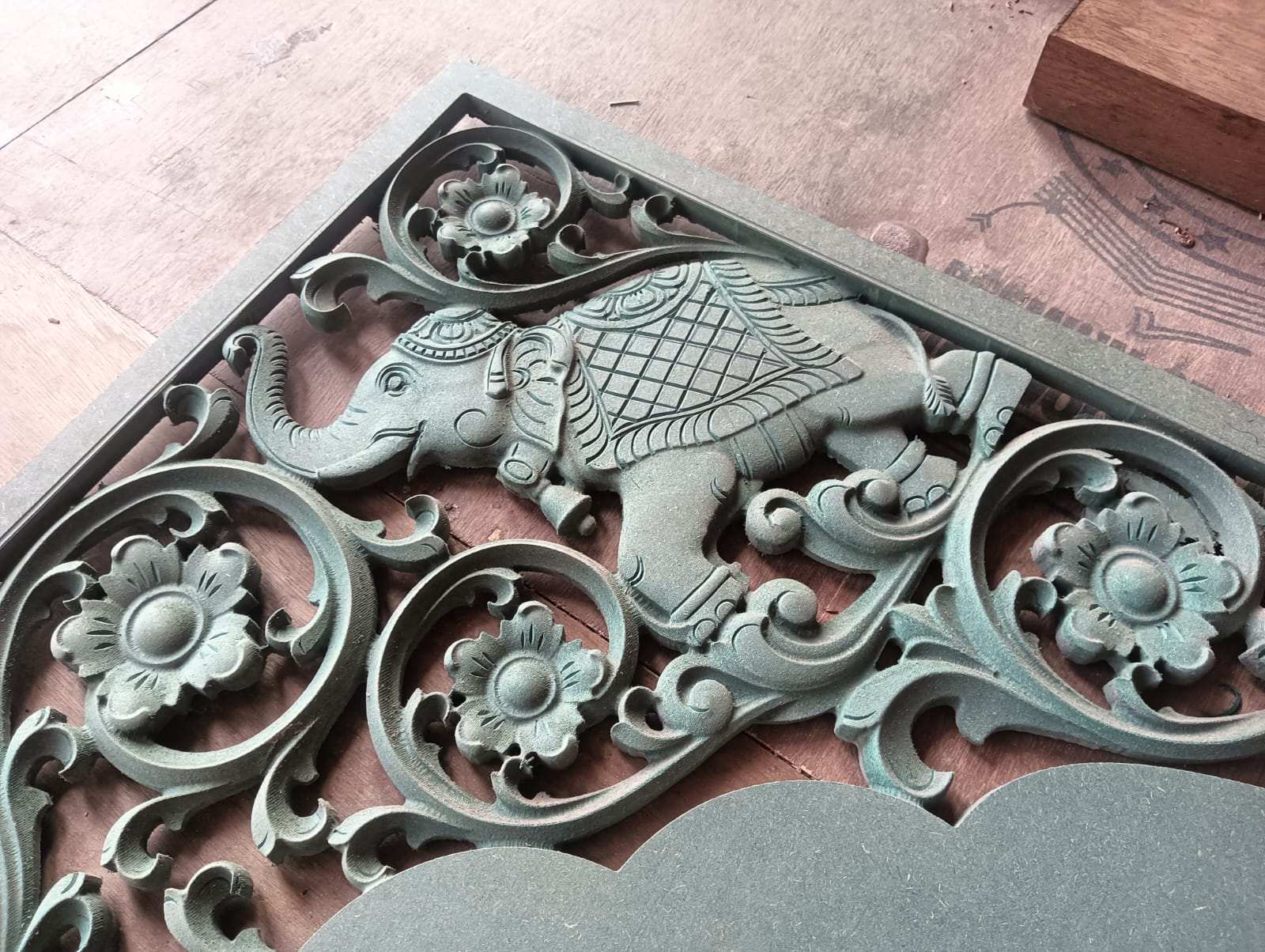 Hoysala-style elephant relief panel carved in green soapstone with elaborate floral scrollwork